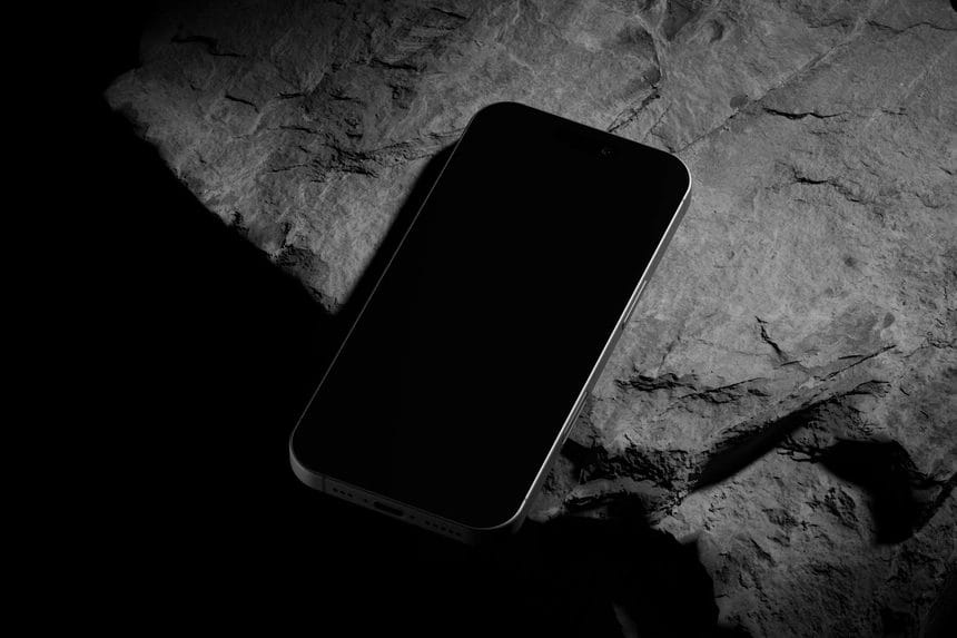free iPhone 16 pro mockup black titanium on rock