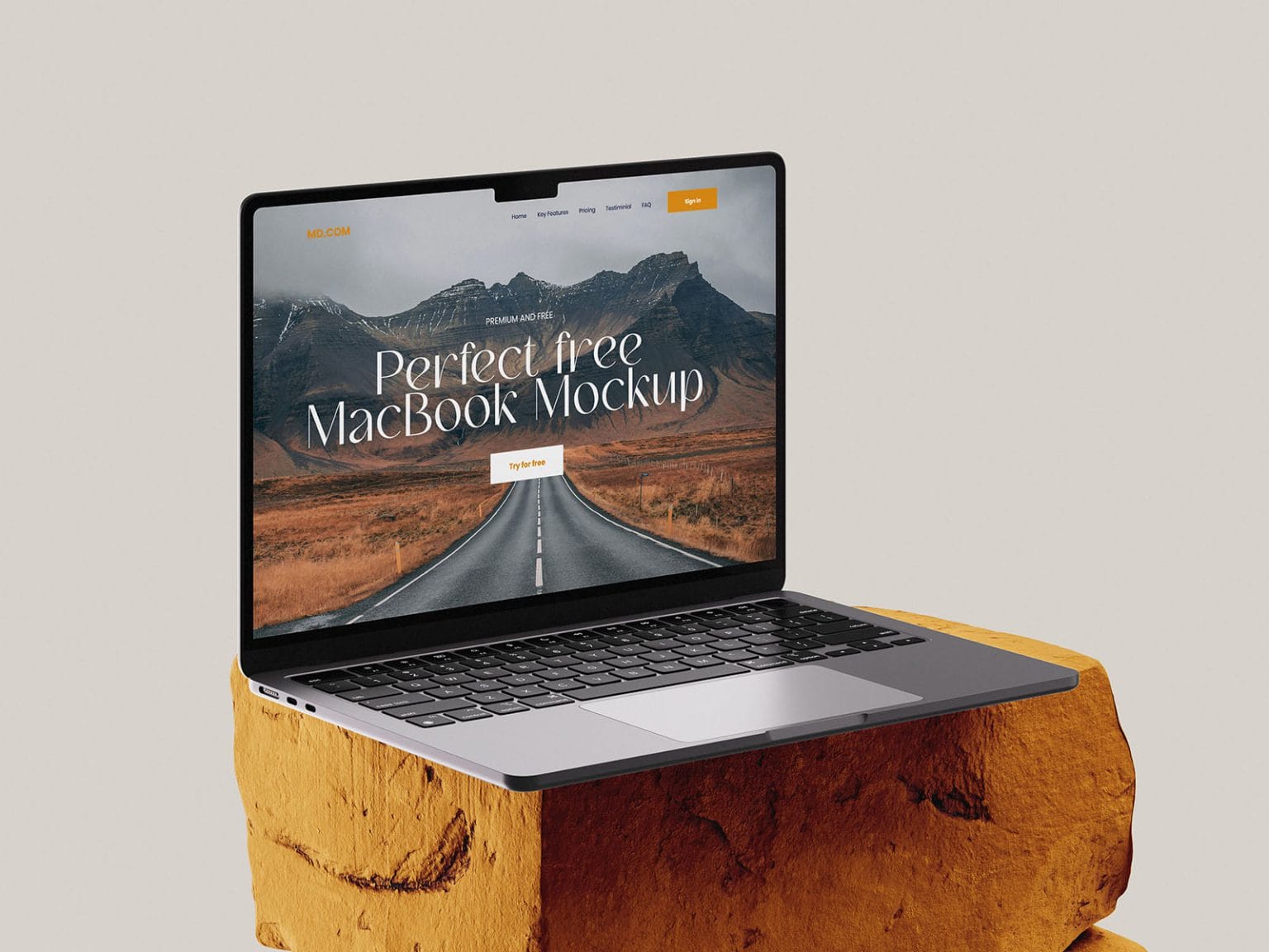 free macbook mockup on stone in left view