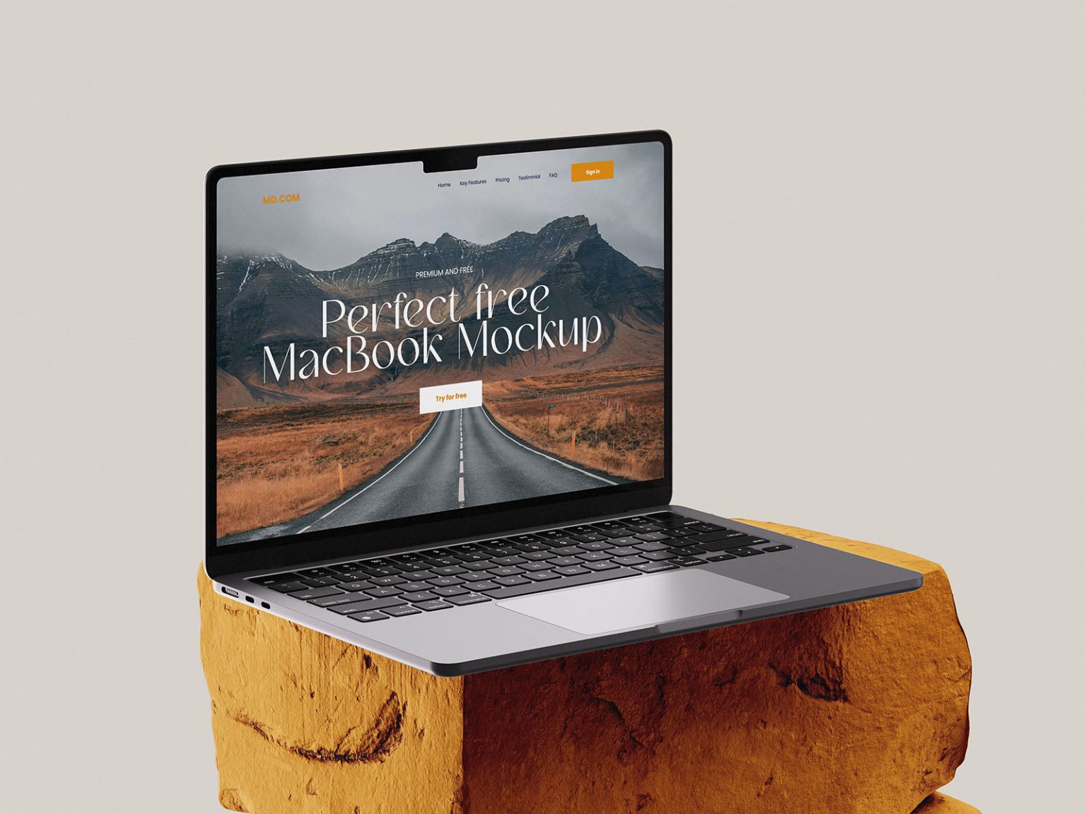 free macbook mockup on stone in left view