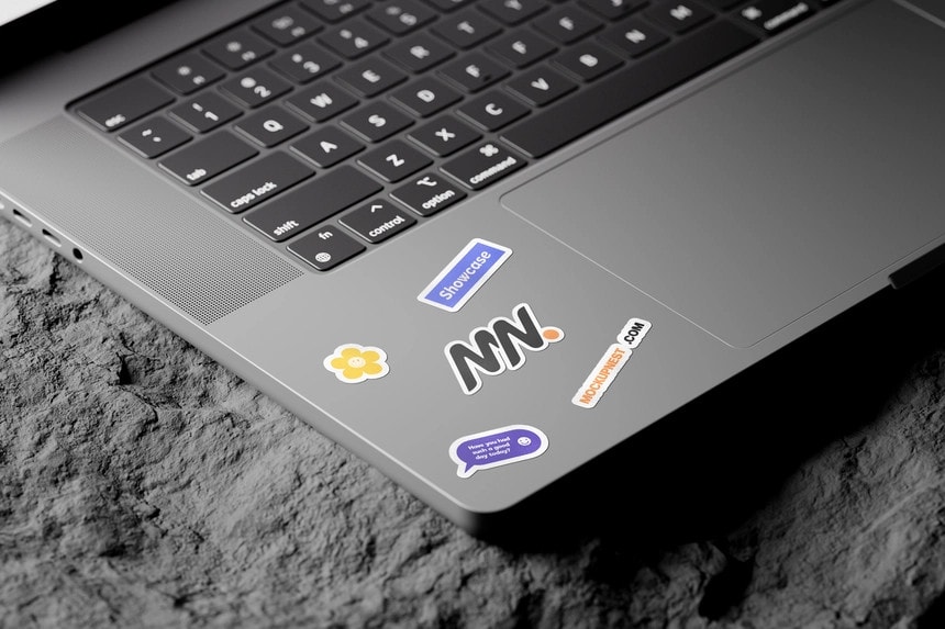 laptop sticker mockup on rock mockup